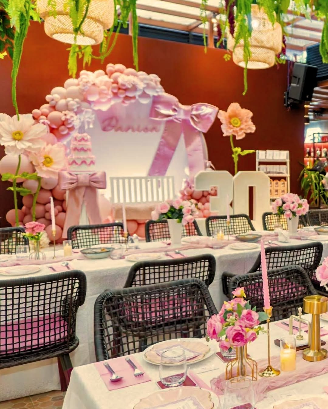 Birthday celebration with pink balloon arch at AMBAI